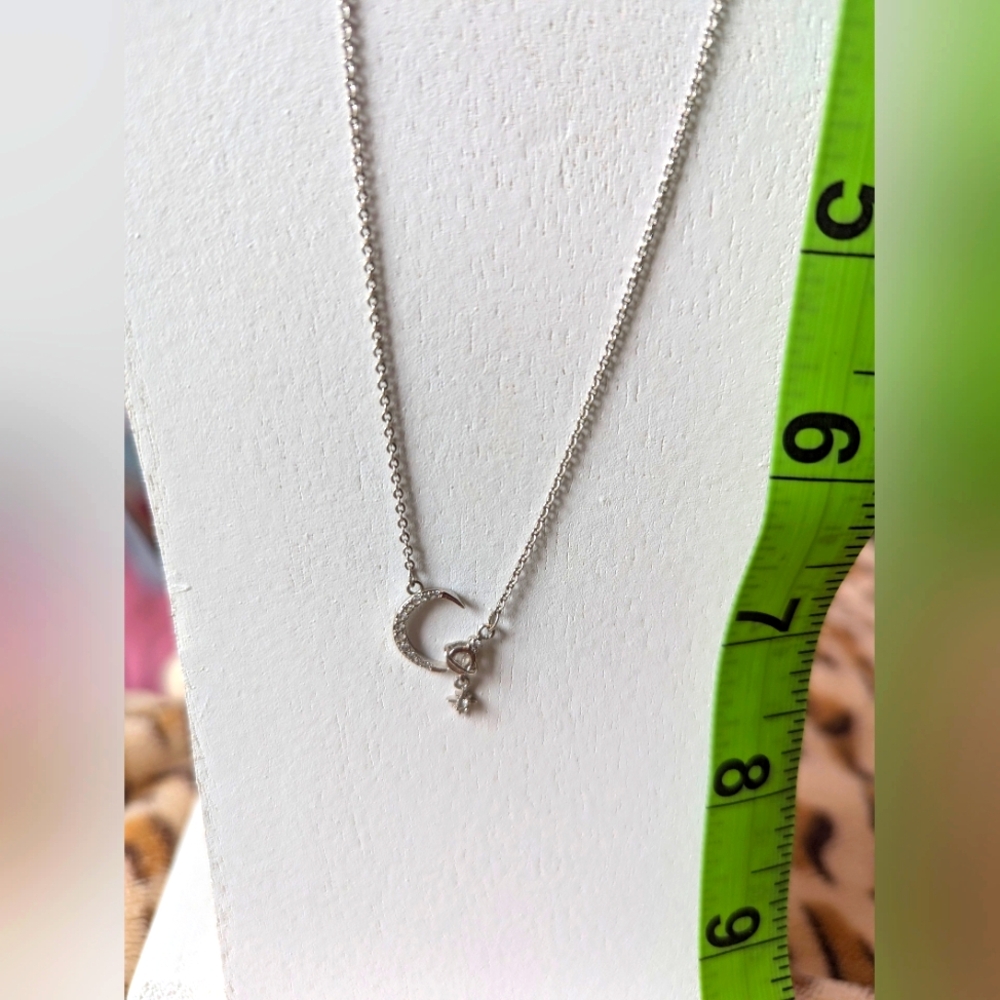 Moon and Star silver necklace with rhinestone detail. Adjustable